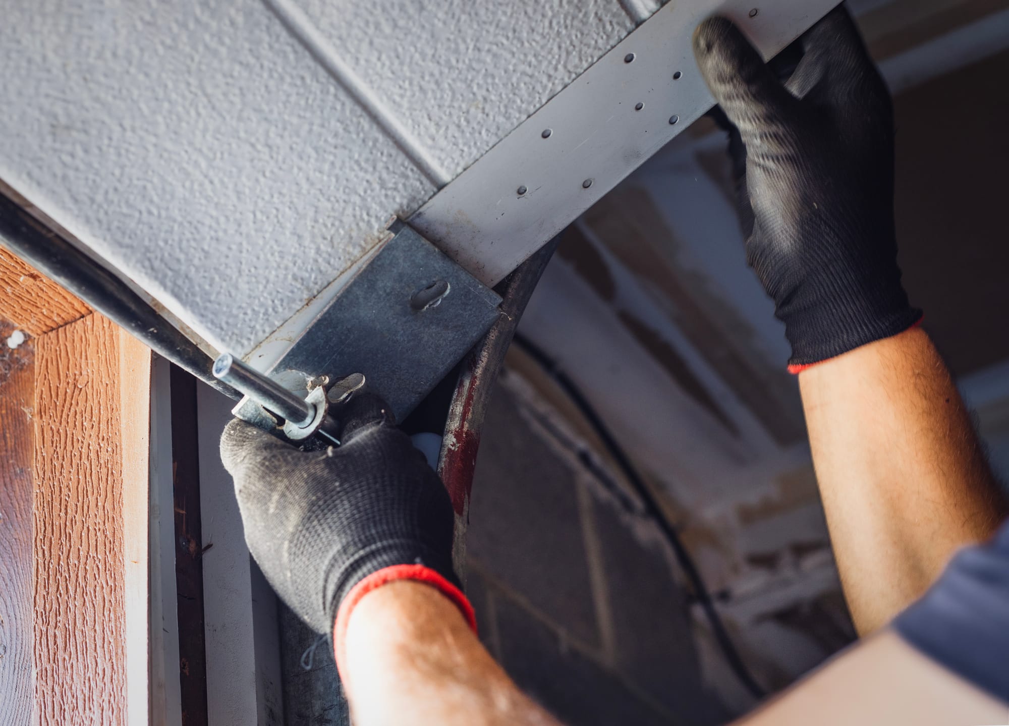 A technician maintaining a residential garage door