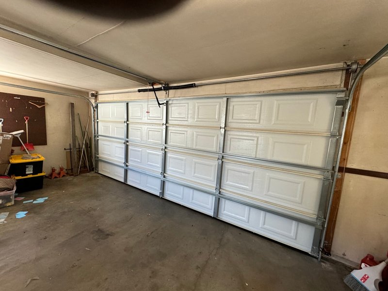 White Raised-Panel Door Interior Track Installation ,  24/7 Garage Door and Gate Services, Inland Empire CA